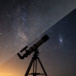 A telescope stands on a tripod, silhouetted against a sky that dramatically contrasts light pollution on the left with a clear, star-studded sky on the right.