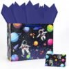 Gift bag with a space theme design, featuring colorful planets, stars, and two astronauts floating; matching card and dark blue tissue paper included.