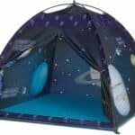 A children’s play tent with space-themed graphics including planets, spacecraft, and dates, set up on a blue floor.